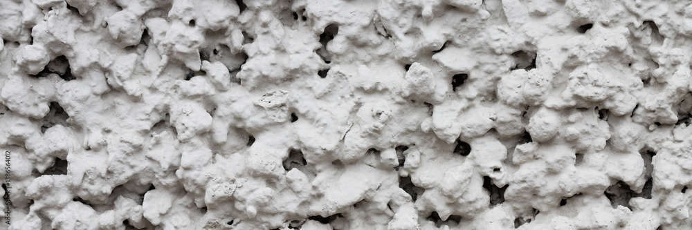 The texture of the gray wall. Decorative plaster. Rough grainy bumpy surface. Wide panoramic texture for background and design.