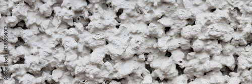 The texture of the gray wall. Decorative plaster.  Rough grainy bumpy surface. Wide panoramic texture for background and design.