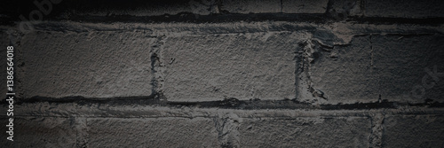Obraz na płótnie Old brick wall. The texture of weathered grungy brickwork. Panorama of a wall with a rough masonry surface. Dark wide panoramic background for design. Shaded vintage texture with dark vignette. w salonie