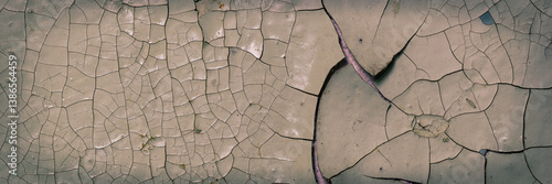 Obraz na płótnie Peeling paint on the wall. Panorama of a concrete wall with old cracked flaking paint. Weathered rough painted surface with patterns of cracks and peeling. Panoramic texture for background and design. w salonie