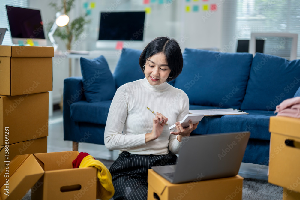 A woman is sitting on the floor in a room with a laptop and a notebook A woman is sitting on the floor in a room with a laptop and a notebook