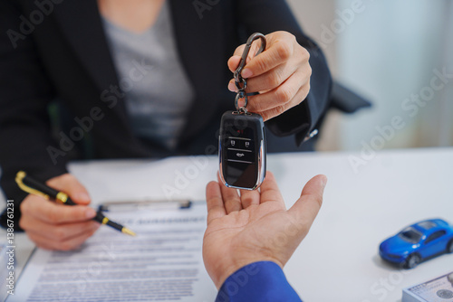 Canvas Print A middle-aged Asian male seller in a formal suit assists a woman buyer at a desk