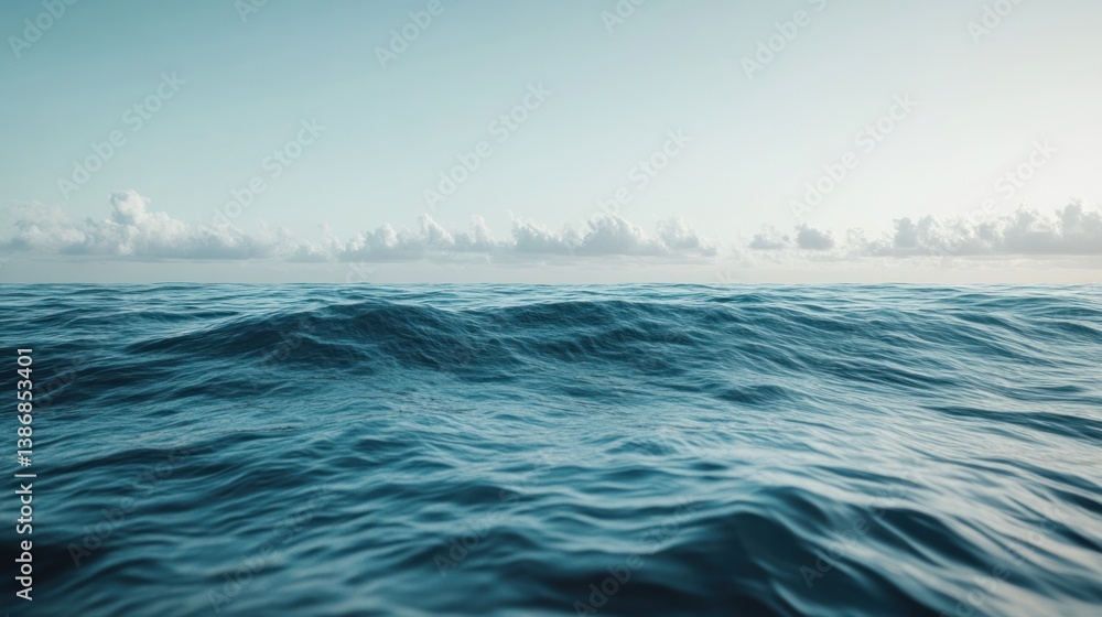 Fototapeta premium Serene Ocean Vista with Gentle Waves Under a Pale Sky Horizon
