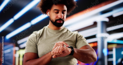 African American athlete monitoring fitness levels with smartwatch