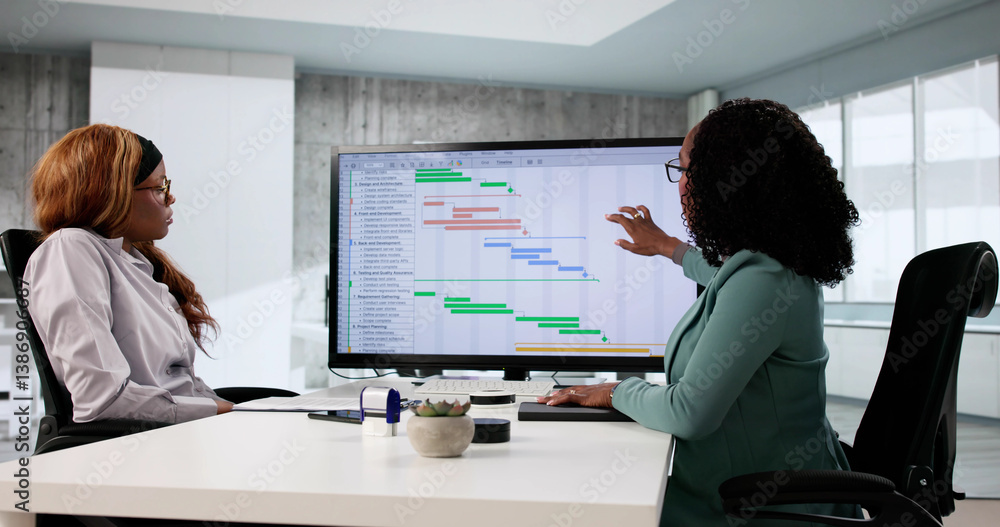 Professional African American woman updating data on touchscreen software