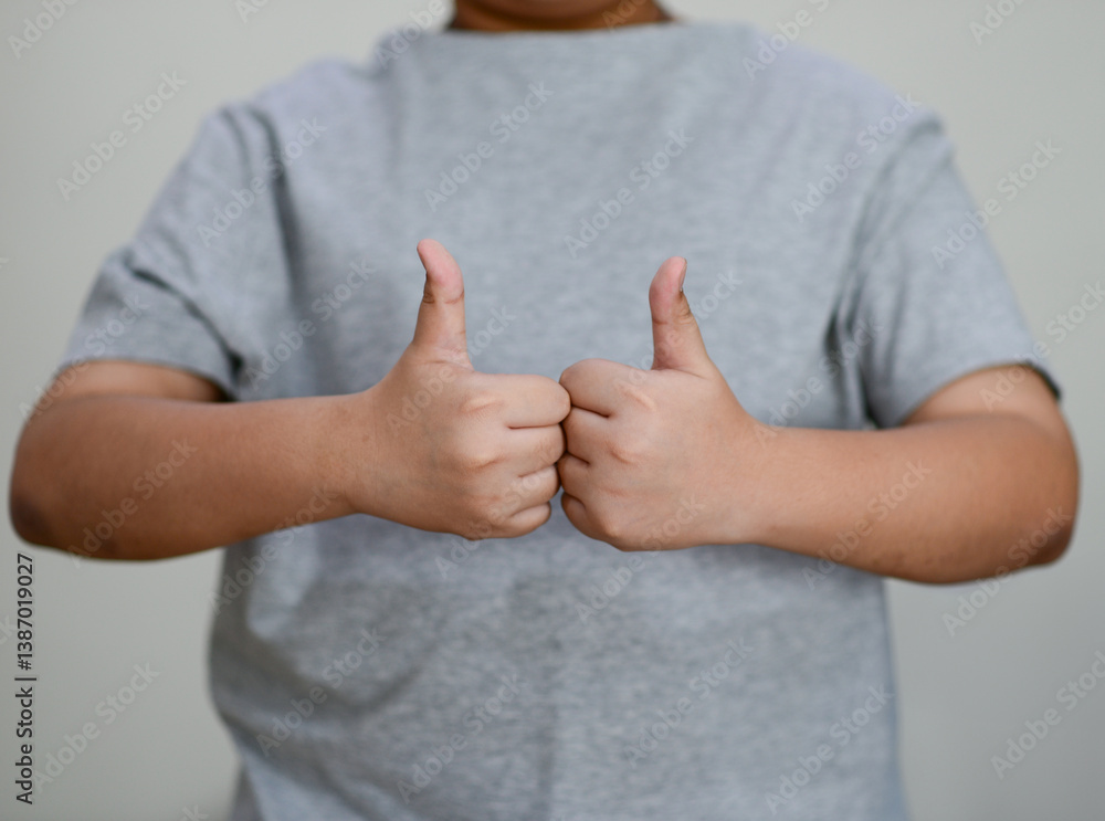 Child's hand thumb up is a symbol
