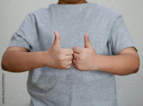 Child's hand thumb up is a symbol