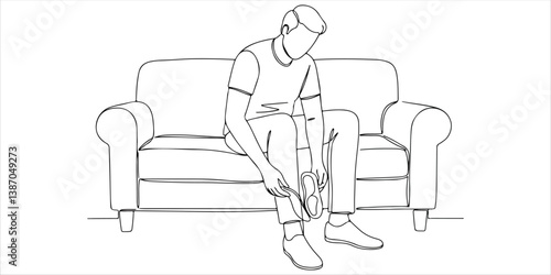 Seated comfortably on the sofa, a man carefully inserts an orthopedic insole into his shoe. With precision, he adjusts its placement, ensuring optimal support and enhanced comfort for his feet