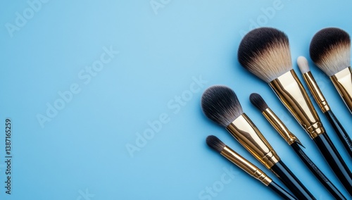 Makeup brushes on a light blue background