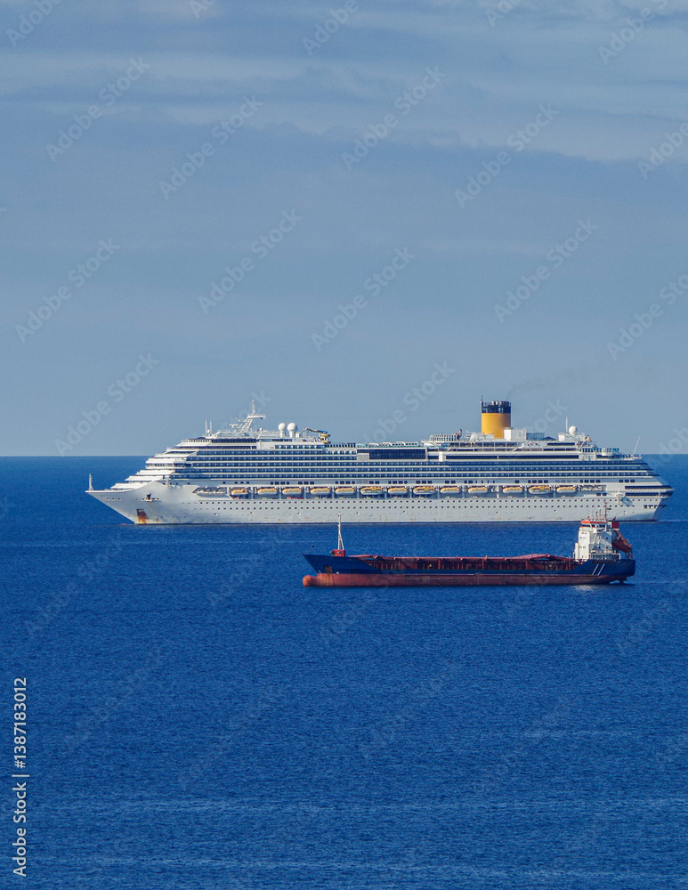 Mega family cruiseship cruise ship liner Favolosa and bunker ship anchored offshore of Civitavecchia Rome, Italy before reactived after Covid pandemic with other vessels in port and coastline