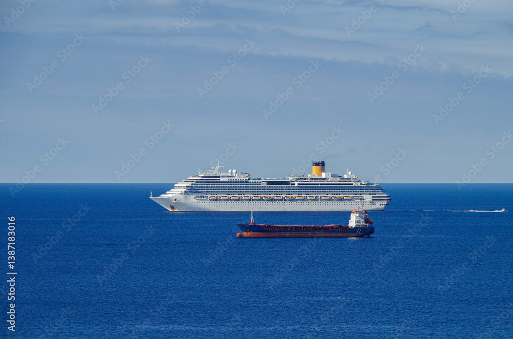 Mega family cruiseship cruise ship liner Favolosa and bunker ship anchored offshore of Civitavecchia Rome, Italy before reactived after Covid pandemic with other vessels in port and coastline