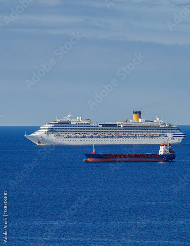 Obraz na płótnie Mega family cruiseship cruise ship liner Favolosa and bunker ship anchored offshore of Civitavecchia Rome, Italy before reactived after Covid pandemic with other vessels in port and coastline w salonie