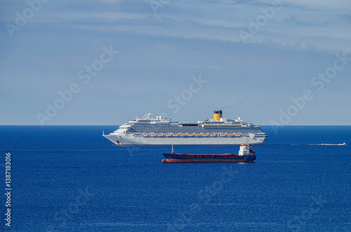 Obraz na płótnie Mega family cruiseship cruise ship liner Favolosa and bunker ship anchored offshore of Civitavecchia Rome, Italy before reactived after Covid pandemic with other vessels in port and coastline w salonie