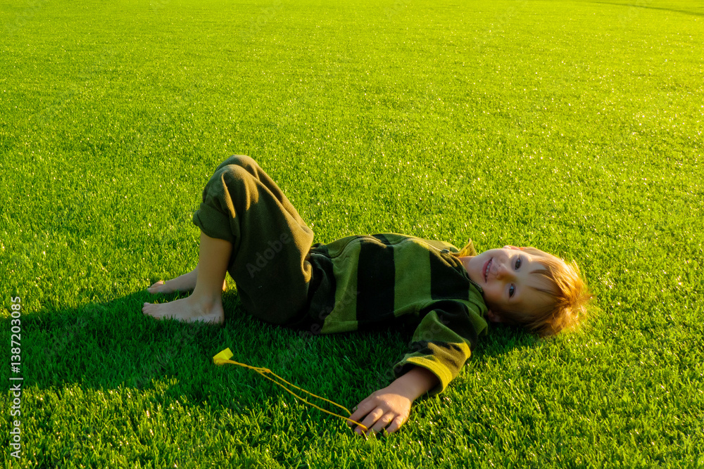 The child goes in for sports at the stadium. The boy training before playing football. High quality photo