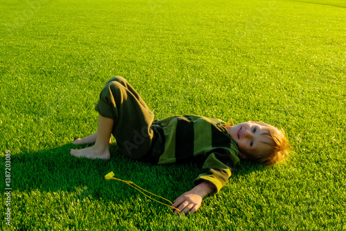 Obraz na płótnie The child goes in for sports at the stadium. The boy training before playing football. High quality photo w salonie