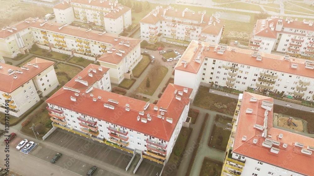 Urban housing estate with red roofs and white facades