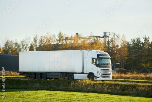 Obraz na płótnie White trailer truck driving forest highway w salonie