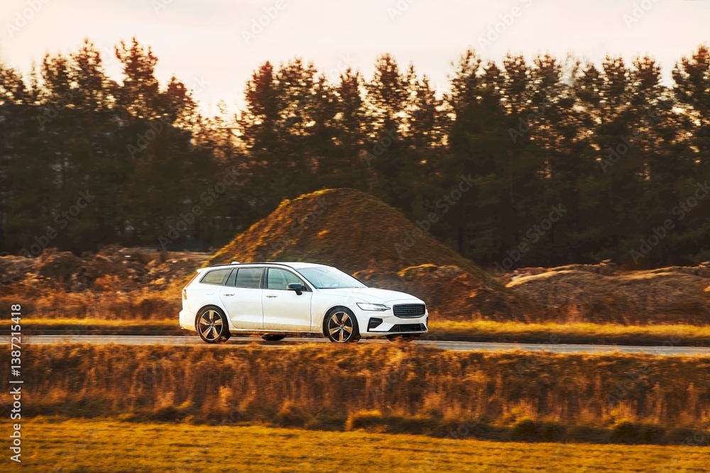 Scenic countryside with white sleek sports wagon