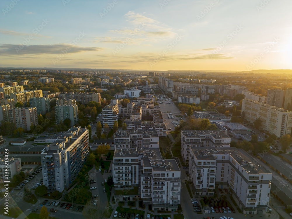 Drone view of city apartments and streets in sunny evening