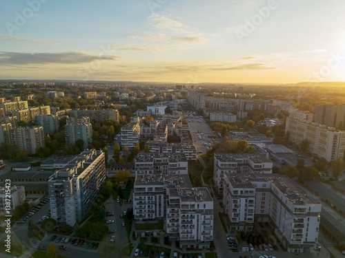 Obraz na płótnie Drone view of city apartments and streets in sunny evening w salonie