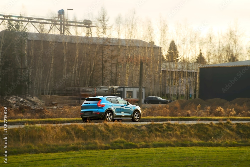 SUV driving through rural landscape