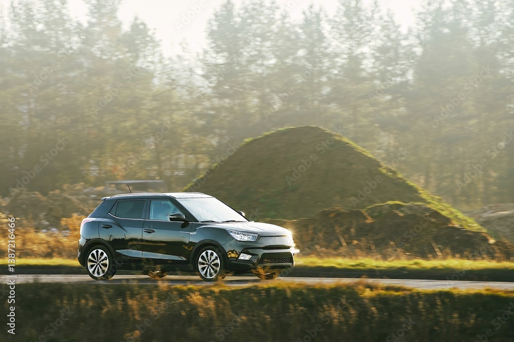 Gray car driving through landscape