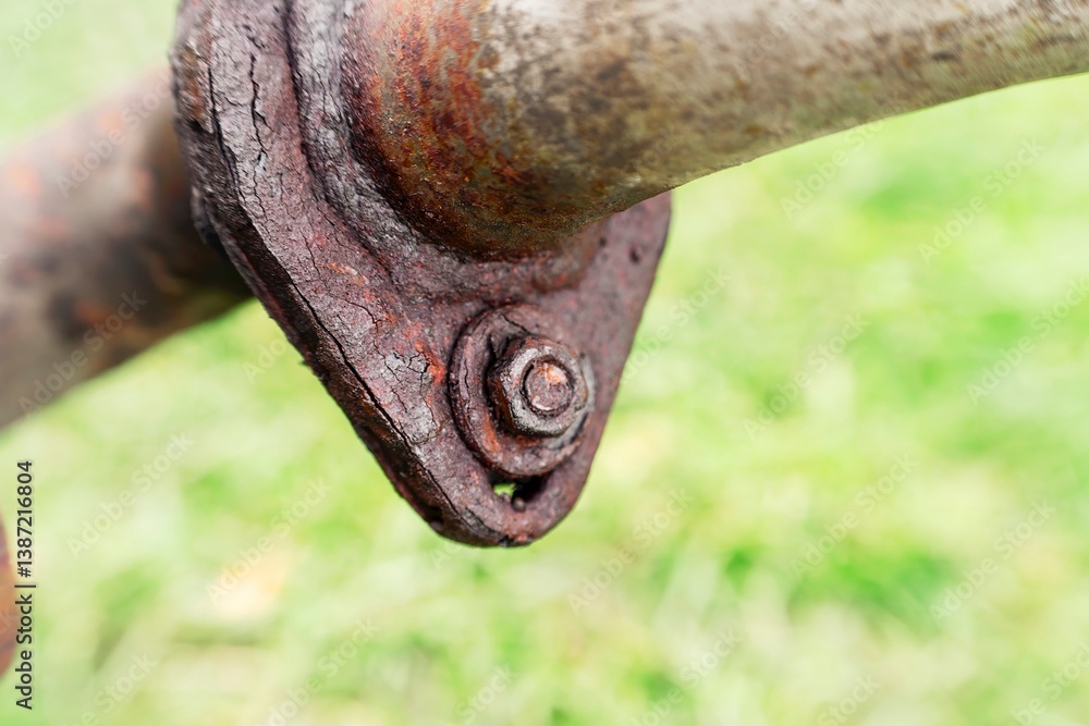 Old rusted bolt on metallic surface