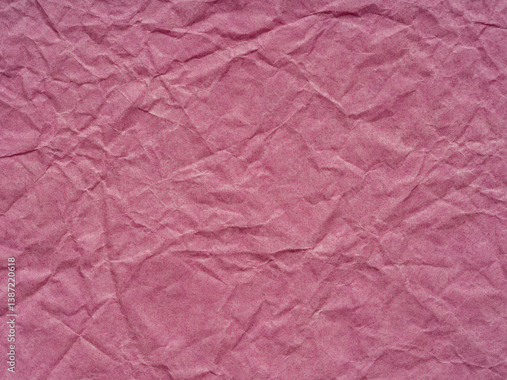 Whispers of blush traverse the crumpled paper landscape, crafting a delicate ballet of texture and hue
