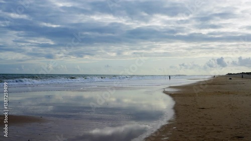 Wallpaper Mural Quiet morning fishing along the reflective wet sands of the beach. High quality 4k footage Torontodigital.ca