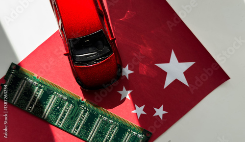 Toy car painted with the flag of china over a little solar panel and microchips. photo
