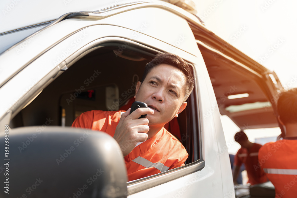 Naklejka premium Paramedic, emergency, ambulance staff and medical help. Ambulance staff member in ambulance car and talking by portable radio during sitting with paramedics giving injured person first aid