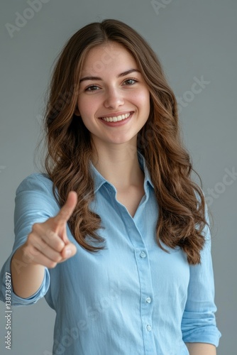 Obraz na płótnie A confident smiling young businesswoman posing for a promotional image in modern office attire, suggesting trustworthy and effective customer service or professional networking. w salonie