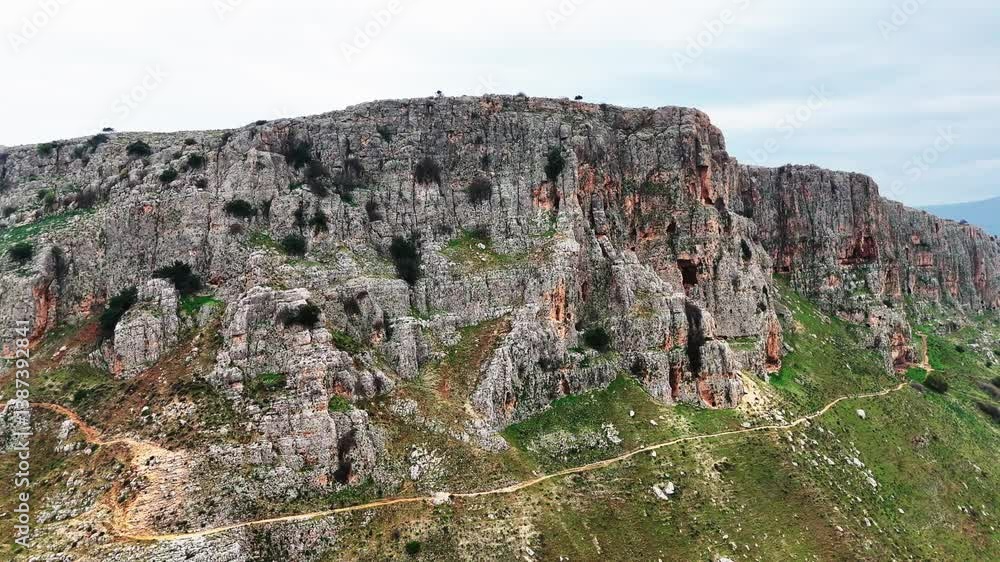 Aerial view of Mount Arbel overlooking the Sea of Galilee. Captured by drone, this breathtaking landscape showcases the dramatic cliffs of Arbel, lush valleys, and the sparkling waters of Lake Kinnere Aerial view of Mount Arbel overlooking the Sea of Galilee. Captured by drone, this breathtaking landscape showcases the dramatic cliffs of Arbel, lush valleys, and the sparkling waters of Lake Kinnere