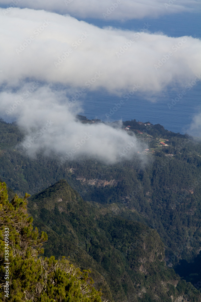 As hikers traverse the Pico do Arieiro to Pico Ruivo trail, they are greeted by panoramic views of towering mountains shrouded in swirling clouds. As hikers traverse the Pico do Arieiro to Pico Ruivo trail, they are greeted by panoramic views of towering mountains shrouded in swirling clouds.