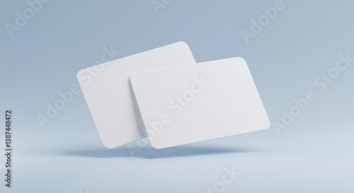 Two blank white cards floating on a light blue background, ideal for business card or credit card mockups