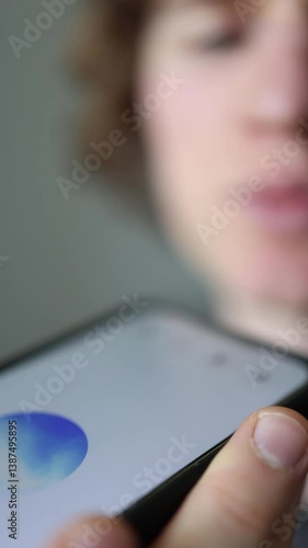 Vertical screen closeup moment as user quietly shares problems with ChatGPT fingers clutch the phone like it’s a lifeline blurry face full of trust hope and silent questions