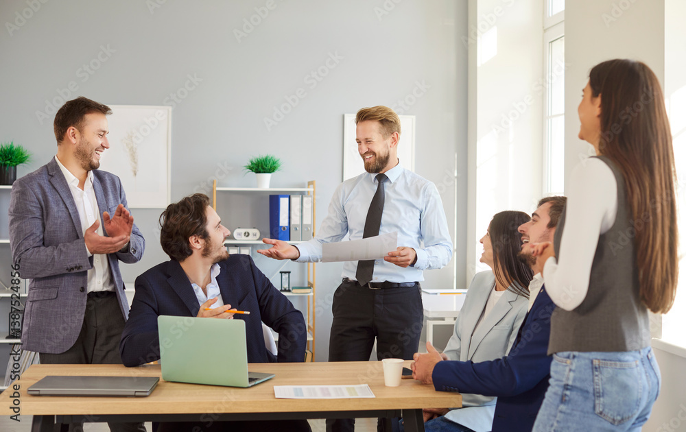 Friendly business people working together in an office during a team meeting, conference, or presentation. Showcasing community, teamwork, and professional collaboration in the workplace.