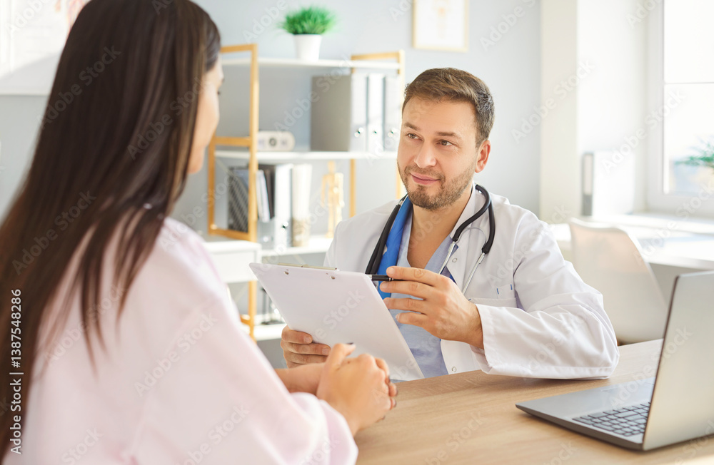 Obraz premium Doctor interviewing a patient. Male physician with a clipboard sitting at his desk with a female patient. Man in a white coat talking to a woman in a medical office. Health care, visit doctor concept