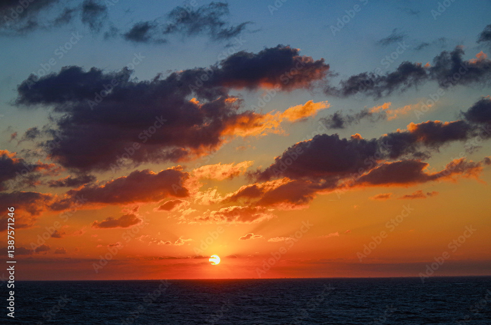 Fototapeta premium Beautiful breathtaking sunset blue hour twilight panorama at sea with dramatic sky seen from outdoor deck of classic cruiseship cruise ship liner sailing on ocean 