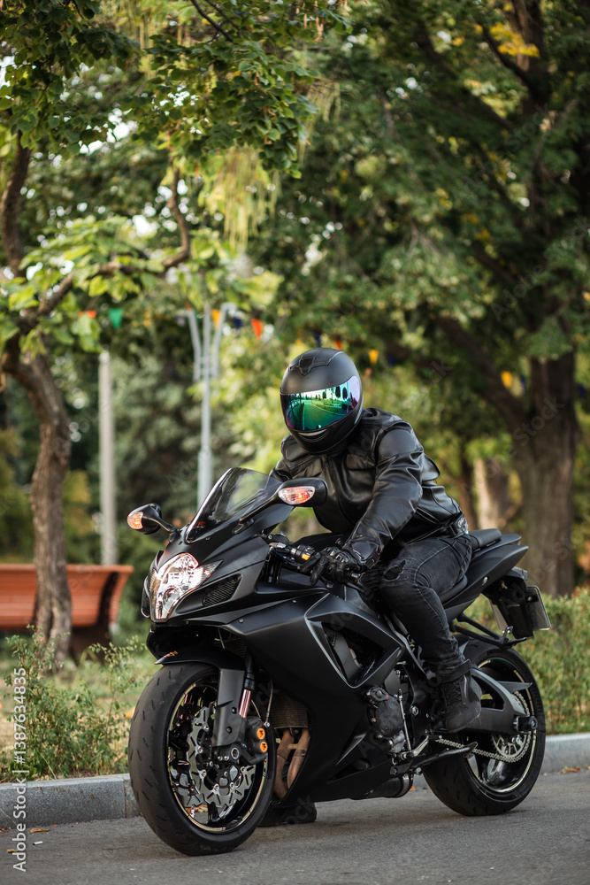 stylish male motorcyclist in a leather jacket and jeans with a classic city motorcycle stylish male motorcyclist in a leather jacket and jeans with a classic city motorcycle