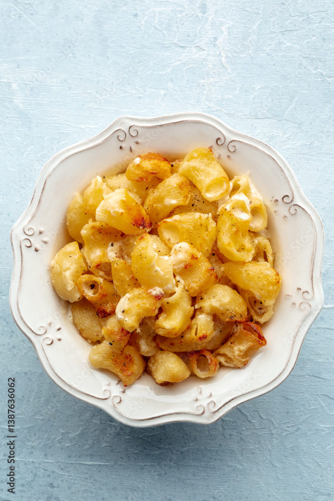 Mac and cheese, the classic pasta with macaroni and Cheddar cheese, baked in the oven, shot from above Mac and cheese, the classic pasta with macaroni and Cheddar cheese, baked in the oven, shot from above