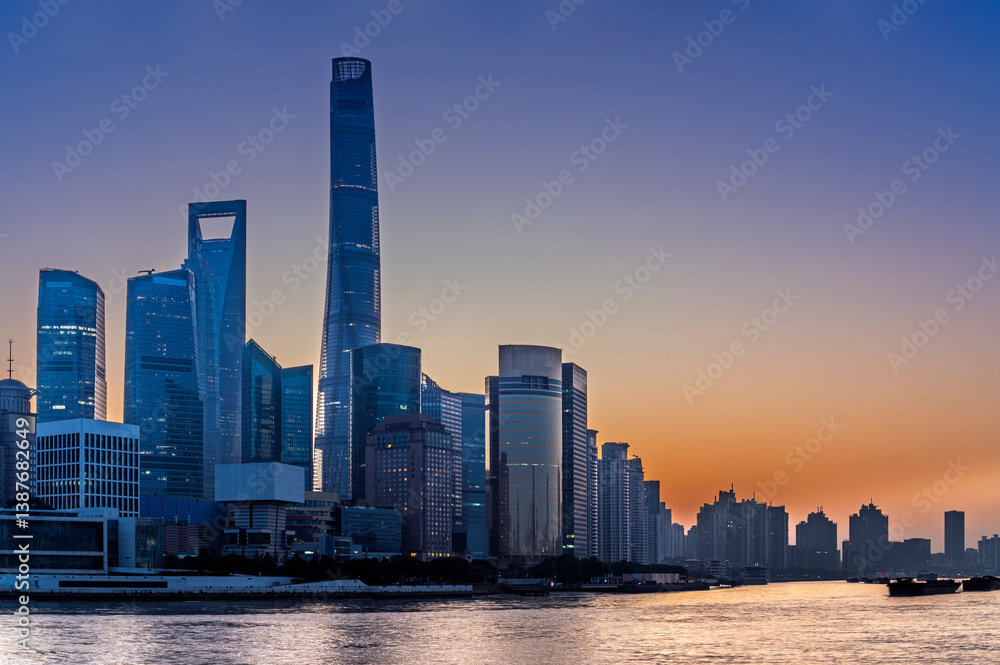 Morning sun rise of Shanghai city modern skyscraper cityscape in blue sky autumn season behind pollution haze, view from the bund in Shanghai, China.
