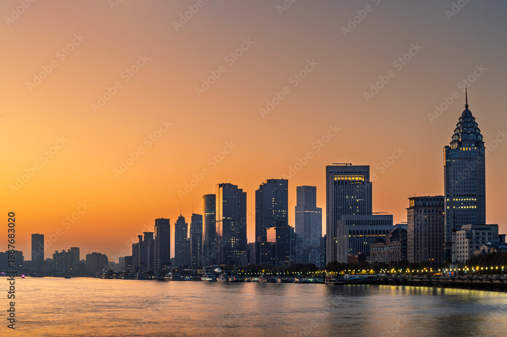 Morning sun rise of Shanghai city modern skyscraper cityscape in blue sky autumn season behind pollution haze, view from the bund in Shanghai, China.