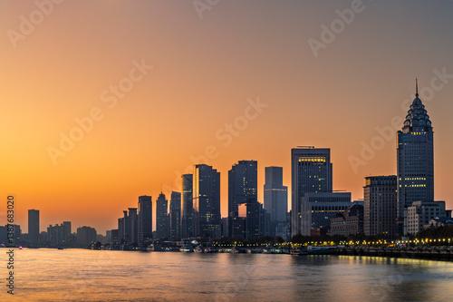 Obraz na płótnie Morning sun rise of Shanghai city modern skyscraper cityscape in blue sky autumn season behind pollution haze, view from the bund in Shanghai, China. w salonie