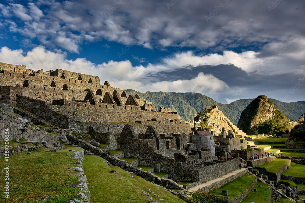 Fototapeta premium Perched high in the Andes, Machu Picchu stands as a testament to the brilliance of the Inca civilization. Surrounded by misty peaks and lush greenery, this ancient wonder inspires awe and reverence 