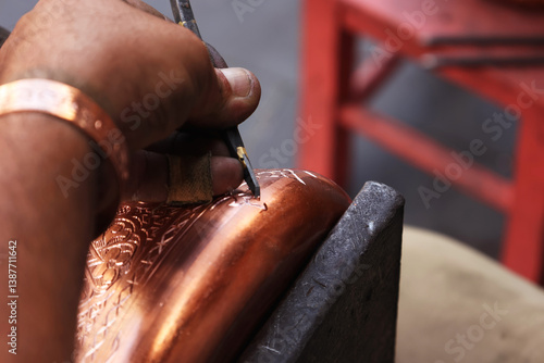 Traditional coppersmithing in Gaziantep. Craftsman engraving on a copper metal plate