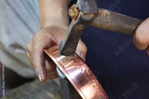 Traditional coppersmithing in Gaziantep. Craftsman engraving on a copper metal plate