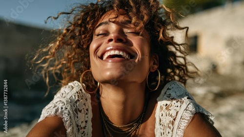 A happy woman with freckles and curly hair enjoys an outdoor setting, vividly expressing her happiness and free spirit while basking in the natural light around her.