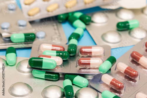 Different pills falling on black background. Drugs, pills, antibiotics, vitamins, healthcare, pharmaceutical industry, drug use, medicine concept.