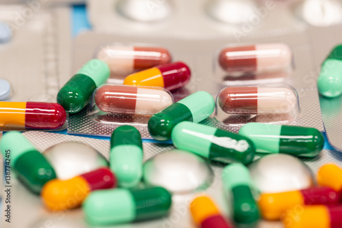 Different pills falling on black background. Drugs, pills, antibiotics, vitamins, healthcare, pharmaceutical industry, drug use, medicine concept.